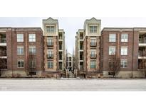 Brick building with multiple units and gated entrance at 450 E Ohio St # 106, Indianapolis, IN 46204