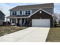 Charming two-story home with a brick-accented garage and inviting front porch with swing at 6250 Bales Dr, Plainfield, IN 46168