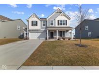 Charming two-story home with a well-manicured lawn and attached two-car garage at 6774 Highland Way, Brownsburg, IN 46112