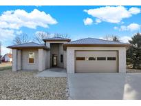 Charming single-story home with a gray brick exterior, attached garage, and well-maintained landscaping at 201 S Mckinley St, North Salem, IN 46165