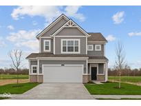 Charming two-story home with gray siding, white trim, two-car garage, and landscaped yard at 2310 Marjorie Way, Shelbyville, IN 46176