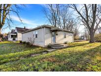 Charming single-story home with a well-maintained yard and classic architectural details at 2319 N Rural St, Indianapolis, IN 46218