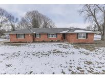 Brick ranch house with snow-covered lawn at 658 Mellowood Dr, Indianapolis, IN 46217
