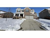 Two story brick home with attached garage and snow covered front yard at 8836 Hornady Ct, Indianapolis, IN 46239