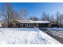 Brick ranch house with snow-covered lawn and attached garage at 9 Wedding Ln, Plainfield, IN 46168