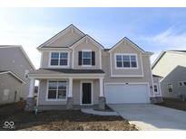 Charming two-story home with a covered front porch, attached garage, and stone accents at 9965 Redwood Peak Ln, Indianapolis, IN 46259