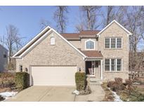 Two-story brick home with attached garage and landscaping at 10402 Shakamak Way, Indianapolis, IN 46239