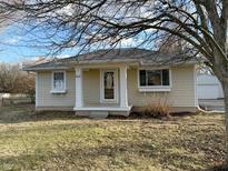 Charming single-story home featuring a front porch with classic white columns at 105 W Sumner Ave, Indianapolis, IN 46217