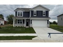 Charming two-story home featuring blue siding, a gray brick facade, and a well-maintained lawn at 116 Marble Wood Dr, Danville, IN 46122