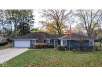 Ranch home with blue siding, white garage door, and landscaping at 1201 Oak Ridge Dr, Indianapolis, IN 46220