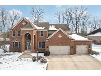 Charming brick home featuring a three-car garage and a welcoming, arched entrance at 16170 Stony Ridge Dr, Noblesville, IN 46060