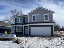 Two-story home with gray and blue siding, white garage door, and a landscaped yard at 5151 Cartland Dr, Indianapolis, IN 46239