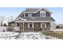 Two-story house with gray siding, covered porch, and snow-covered lawn at 5371 Lue Ann Ln, Mooresville, IN 46158