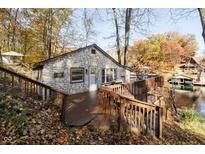 Stone house with deck overlooking lake; fall foliage at 7018 Drum Dr, Nineveh, IN 46164