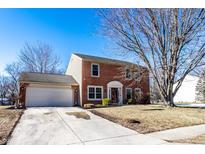 Brick home with attached garage and landscaping at 7150 Tappan Dr, Indianapolis, IN 46268