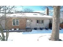 Charming single-story home with brick and siding, complemented by a snow-covered yard at 7468 Prairie Lake Dr, Indianapolis, IN 46256