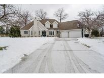 Two-story house with a snow covered driveway and attached garage at 10295 Summerlin Way, Fishers, IN 46037