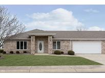 Charming brick home featuring a well-maintained lawn and attached two-car garage at 116 Jasper Way, Anderson, IN 46012