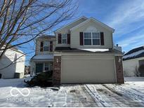 Two-story house with beige siding, brown shutters, and a two-car garage at 11663 Congressional Ln, Indianapolis, IN 46235