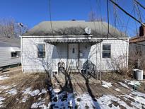 White single story home with small front porch at 1440 Udell St, Indianapolis, IN 46208