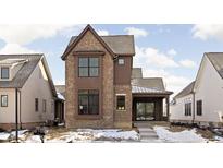 Brick two-story home with a metal roof and walkway at 17333 Ackerson Blvd, Westfield, IN 46074