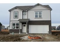 A two-story home with gray siding, brick accents, an attached two-car garage and a welcoming front porch at 2178 Warbler St, Danville, IN 46122