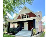 Charming red and white two-story home with a gray porch and landscaping at 52 N Mount St, Indianapolis, IN 46222