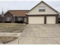 Brick home with large two car garage, brown roof, and dormant landscaping at 8306 Hunters Meadow Way, Indianapolis, IN 46259