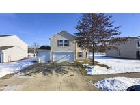 Two-story house with attached garage and snow-covered yard at 8331 Firefly Way, Indianapolis, IN 46259