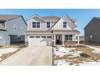 Two-story house with gray siding, brick accents, and a two-car garage at 8576 Jeff Cir, Brownsburg, IN 46112