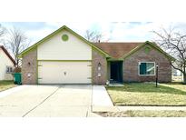 Charming single-story brick home with a two-car garage and well-maintained front lawn at 1520 Wilford Ln, Indianapolis, IN 46229