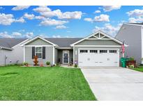 Gray siding, two-car garage, and landscaped lawn at 3131 E Maygrove Dr, Danville, IN 46122