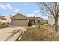 Charming single Gathering home featuring a well manicured lawn and an attached two car garage at 352 Parkview Dr, Danville, IN 46122
