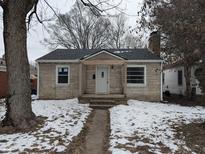 Brick house with a covered porch and a small front yard at 3721 Kinnear Ave, Indianapolis, IN 46218