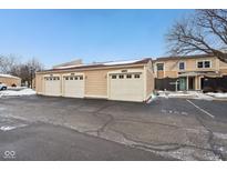 Attached garage with three garage doors and parking spaces at 5152 Coppertree Ln, Avon, IN 46123