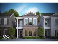 Two-story home with brick and siding exterior, balcony, and landscaping at 525 Gilder Dr, Carmel, IN 46032