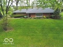 Charming single story home with mature landscaping and a well-manicured lawn at 5420 Skyridge Dr, Indianapolis, IN 46250
