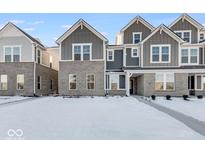 Two-story townhome with gray siding, white trim, and a snowy front yard at 5751 Cr W 750 N, McCordsville, IN 46055