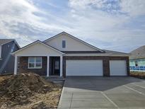Charming single-Gathering home featuring a three-car garage and a welcoming entrance, awaiting landscaping to complete its appeal at 6033 Granby Dr, Whitestown, IN 46075