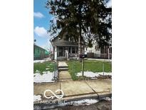 Cute bungalow with front porch, steps, and fenced yard at 1348 N Lasalle St, Indianapolis, IN 46201