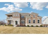 Two-story brick home with a balcony and landscaped lawn at 14292 Dufton Ct, Carmel, IN 46074