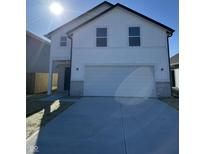 Charming two-story home with a white facade, brick accents, and attached garage at 1440 Wigwam Ln, Martinsville, IN 46151