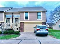 Exterior of charming condo with attached garage and landscaping at 1842 Queensbridge Dr, Indianapolis, IN 46219