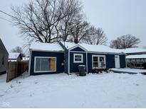 Blue house with white trim, snow covered yard at 2317 Fowler St, Anderson, IN 46012