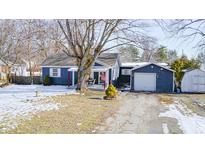 Charming one-story home with a covered porch, detached garage, and shed at 233 S Routiers Ave, Indianapolis, IN 46219