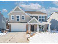 Two-story house with gray and beige siding, a white garage door, and a covered porch at 2406 Ninebark Dr, Plainfield, IN 46168