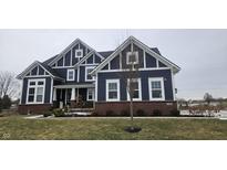 Charming two-story home with blue siding, brick accents, and white trim details at 2420 Rippling Creek Ct, Westfield, IN 46074