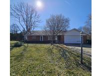 Charming brick home with a well-maintained lawn on a sunny day at 2509 W Euclid Ave, Muncie, IN 47304