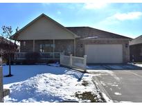 Brick ranch home with attached garage, porch, and snow-covered yard at 5419 E Shae Lake Dr, Mooresville, IN 46158