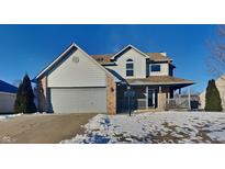 Two-story house with attached garage and snowy front yard at 604 Harvest Ridge Dr, Avon, IN 46123